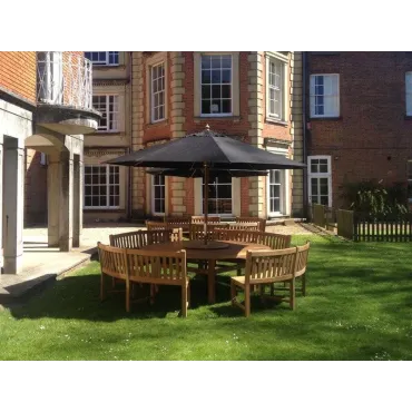 Chunky 210cm dia teak table with contour benches & parasol